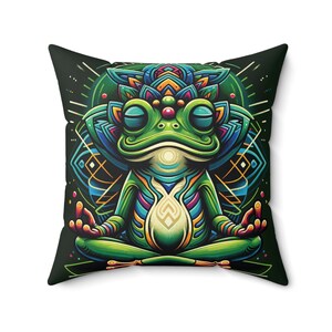 May include: A green frog with colourful patterns sits in a meditative pose with its eyes closed. The frog is surrounded by a mandala-like design with geometric shapes and a dark green background.