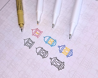 May include: A white sheet of paper with a grid pattern. Six outlined lanterns are coloured in with different coloured markers. The markers are lying on the paper.