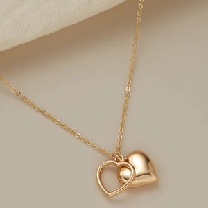 Delicate,modern, silver and gold sweet necklaces with two simply intertwined hearts. Perfect for any occasion. image 3