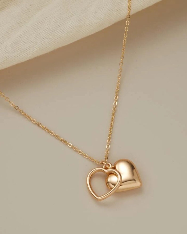 Delicate,modern, silver and gold sweet necklaces with two simply intertwined hearts. Perfect for any occasion. image 3