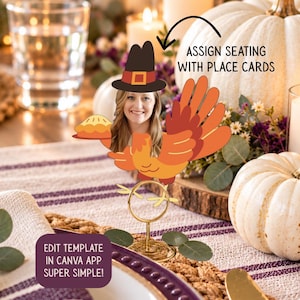 May include: A turkey-shaped place card holder featuring a cutout of a person's face wearing a pilgrim hat, holding a pie, and standing on a gold metal wire base. Text on the image reads: ASSIGN SEATING WITH PLACE CARDS and EDIT TEMPLATE IN CANVA APP SUPER SIMPLE!