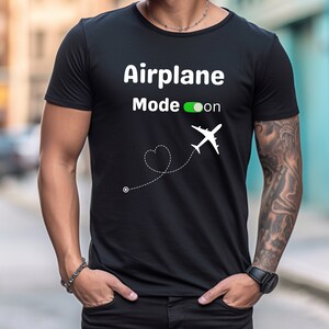 May include: Black t-shirt with white text that reads "Airplane Mode on" and a white airplane icon with a dotted line and heart shape.