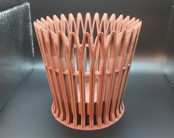 May include: A terracotta-colored, 3D printed planter with a unique, geometric design. The planter has a wide, open top and a narrow base, creating a modern and stylish look.