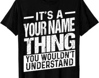 May include: Black t-shirt with white text that reads "IT'S A YOUR NAME THING YOU WOULDN'T UNDERSTAND". The text is in a distressed font. The shirt is a crew neck style.