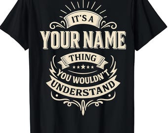 May include: Black t-shirt with a white graphic design. The design includes the text "IT'S A YOUR NAME THING YOU WOULDN'T UNDERSTAND" in a stylized font. The shirt is a crew neck style.