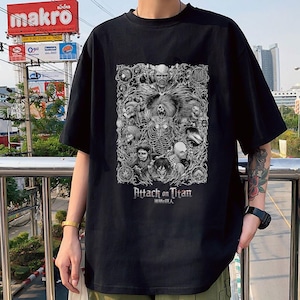 May include: Black t-shirt with a graphic print of characters from the anime Attack on Titan. The text "Attack on Titan" and the Japanese characters "進撃の巨人" are printed below the graphic.