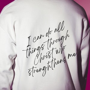 May include: White long-sleeve sweatshirt with the text "I can do all things through Christ who strengthens me" printed on the back.
