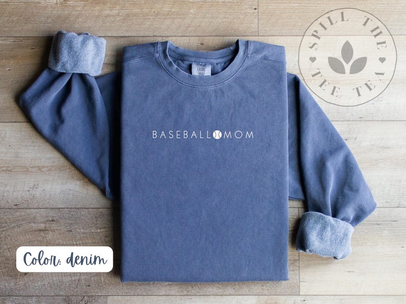 May include: A denim blue sweatshirt with the text "BASEBALL MOM" and a baseball graphic in white.