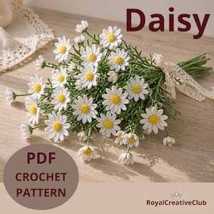 May include: A bouquet of crocheted daisies with white petals and yellow centers, tied with a cream-colored lace ribbon. The word "Daisy" is displayed in a burgundy font. The text "PDF Crochet Pattern" is also visible.