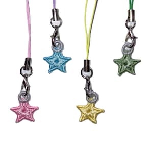 May include: Four colorful star-shaped phone charms. Each charm has a different color star: pink, blue, yellow, and green. Each star is attached to a silver-colored clasp and a matching colored lanyard.