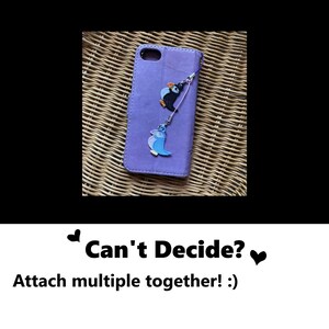 Can't decide? Attach multiple together! Multiple charms can be attached together. This photo shows two charms attached together using the phone charm straps on a phone case.