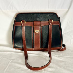 Cartera vintage Carryland de cuero negro y tostado con múltiples compartimentos