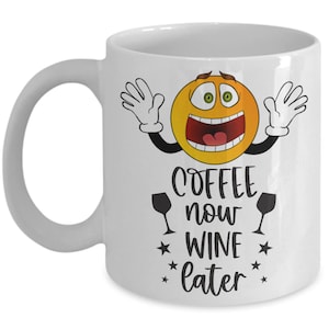 May include: White ceramic coffee mug with a yellow cartoon face with wide eyes and an open mouth. The mug has black text that reads "Coffee now Wine later" with a wine glass icon on either side of the word "now".