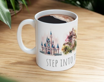 May include: White ceramic mug with a watercolor illustration of Cinderella's Castle and the Haunted Mansion. The mug has the text "STEP INTO THE" printed on the bottom.