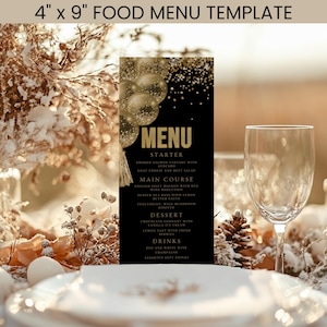 Puede incluir: Una plantilla de menú de comida negra y dorada, de aproximadamente 10 x 23 cm, con un menú para una comida de varios platos. El menú incluye entrantes, platos principales, postres y bebidas. El diseño presenta globos y confeti dorados.