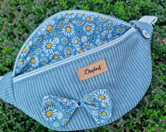 Light blue corduroy fanny pack with bow.