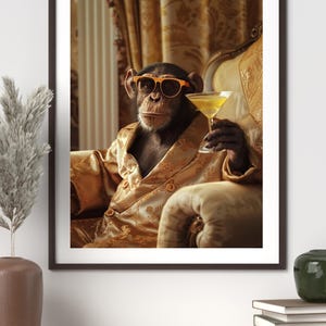 May include: Framed print featuring a chimpanzee wearing orange sunglasses and a gold robe, holding a martini. The chimp is seated in a plush armchair. The background includes gold curtains, creating a luxurious theme.