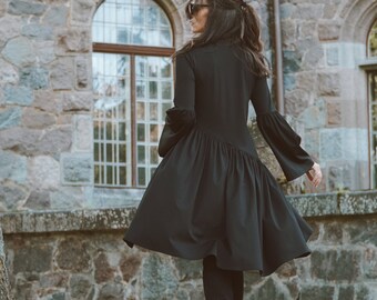 Black dress with a slanted flounce and flared sleeves, KRIKL clothing