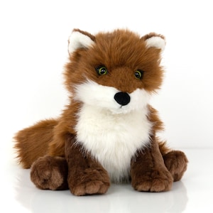 May include: A plush fox toy with brown fur, a white chest, and black eyes. The fox is sitting with its paws in front of it.