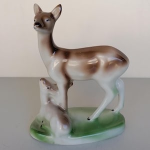 porcelain figurine of a doe with her cub made in Bulgaria vintage sculpture of a deer in white brown color on a green base animal  ornament