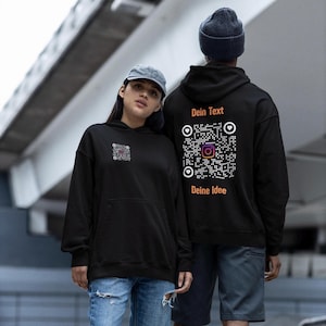 May include: Two people wearing black hoodies with Instagram QR code designs. The front of the hoodie on the left has a small QR code. The back of the other hoodie has a large QR code with the text "Dein Text" above and "Deine Idee" below.