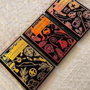 SU ORDINAZIONE - La serie Hunger Games - Libro rilegato a mano con copertina personalizzata
