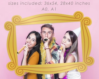 May include: Three friends pose for a photo in a gold-colored Friends TV show-style selfie frame. The frame is on a pink background. The frame is available in sizes 36x54, 28x40 inches, A0, and A1.