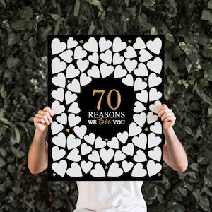 May include: Black and gold sign with 70 white hearts surrounding the text "70 Reasons We Love You".