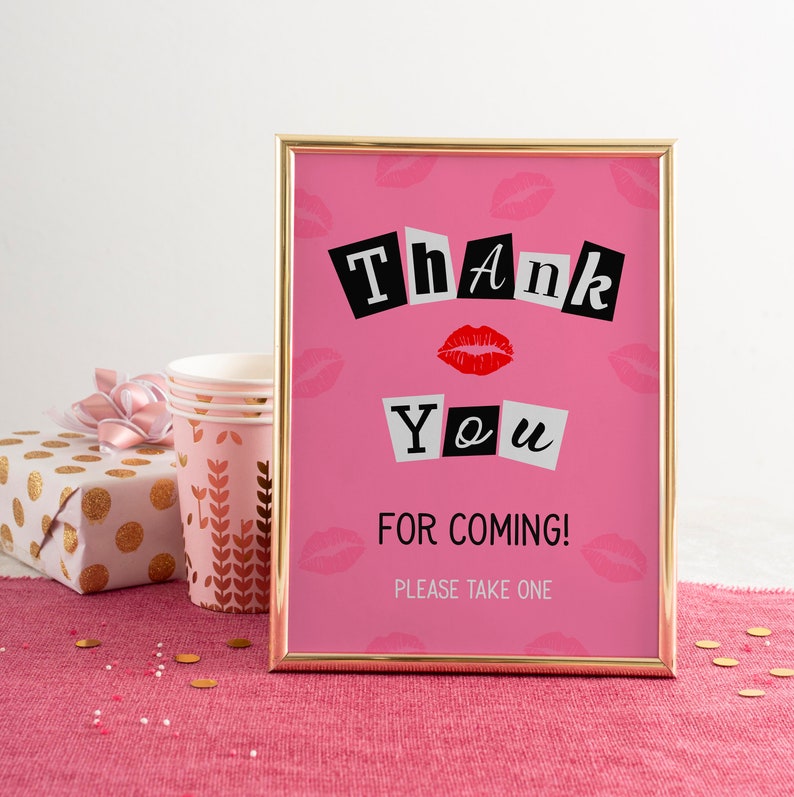 May include: A pink thank you sign with a gold frame. The sign has a black and white "Thank You" text with red lips and the words "For Coming! Please Take One".