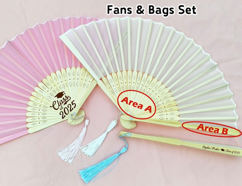 May include: Two hand fans with wooden handles and fabric covers. The pink fan has a graduation design with the text "Class of 2025". The white fan has the text "Area A" and "Area B" on the handle. The handle also has the text "Stephen Parker Class of 2025".