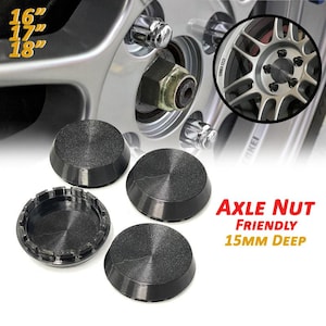 May include: Black axle nut covers with a textured surface, designed to fit wheels with 16", 17", and 18" rims. The image also shows a close-up of a wheel and the text "Axle Nut Friendly 15mm Deep".
