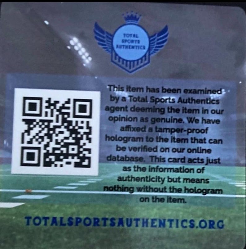 Puede incluir: Una tarjeta transparente con un c&oacute;digo QR y texto de Total Sports Authentics. El texto explica la autenticidad del art&iacute;culo, verificada por un holograma. El logotipo muestra un escudo con alas. La direcci&oacute;n del sitio web tambi&eacute;n es visible.