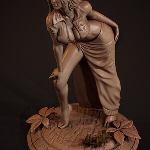 May include: A brown clay sculpture of a woman wearing a long, flowing skirt and a shirt with a floral design. The sculpture is standing on a circular base with a textured surface.