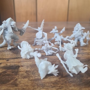 May include: A set of nine gray plastic miniature figurines, depicting fantasy characters, including a goblin, a warrior, and a winged creature. The figurines are posed in various action poses, with swords, shields, and other weapons.