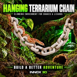 May include: A beige plastic hanging terrarium chain with interlocking links, featuring a patterned orange and white snake resting on the chain. The text reads HANGING TERRARIUM CHAIN, CLIMBING ENRICHMENT FOR SNAKES & LIZARDS, BUILD A BETTER ADVENTURE, INNOX 3D.