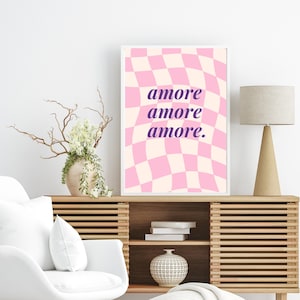 May include: A pink and white checkered print with a wavy pattern. The text "amore amore amore." is written in purple on the print.