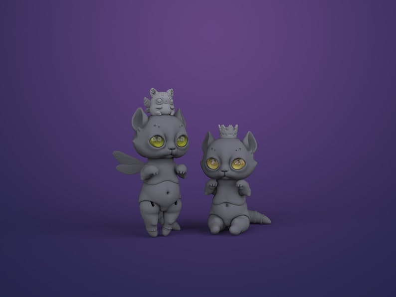 2 gray digital articulated cat dolls in a royal purple studio. Right one with yellow eyes sits and has a crown, left one with green eyes stands and has dragonfly wings and cute chubby winged animal on its head.