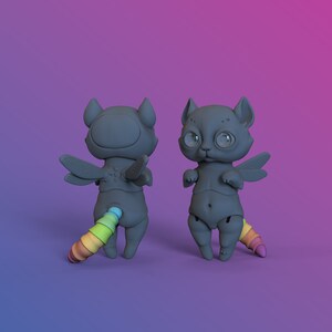 2 digital 3D printable dark gray ball jointed doll cats with rainbow coloured tails in a purple studio standing on hind legs, one is turned backwards to show wings and tail in more detail.