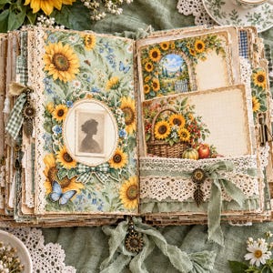 May include: An open scrapbook featuring sunflower-themed pages with lace trim, a silhouette portrait in an oval frame, a basket of sunflowers illustration, and a blue butterfly. The pages include green gingham ribbons, metal sunflower charms, and fabric accents.