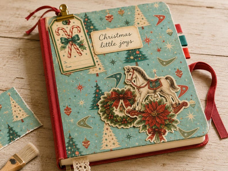 May include: A journal with a light blue cover featuring a pattern of Christmas trees, stars, and ornaments. It includes a tag with candy canes, a label reading "Christmas little joys," a rocking horse, a wreath, and a poinsettia with red ribbons.