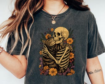Skeleton Hugging Cat Floral Halloween Comfort Shirt Cute Spooky Unisex Shirt – Unique Gift Idea for Cat Lovers