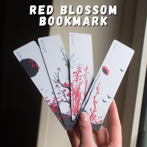 Puede incluir: Cuatro marcadores blancos con diseños de flores rojas y detalles en negro se muestran en abanico. Los marcadores tienen una estética japonesa, con ilustraciones de flores, pájaros y un sol poniente. El texto "RED BLOSSOM BOOKMARK" está en la parte superior.