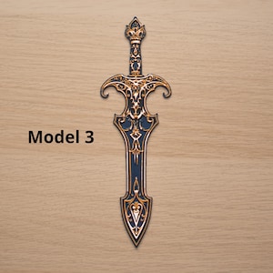 May include: A decorative sword with intricate gold and navy blue detailing. The sword features a detailed hilt and blade design, with the text "Model 3" on the left side. The overall design is ornate and stylized.