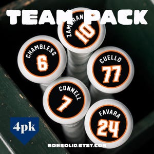 May include: A set of four white baseball bat knobs featuring black circular labels with orange borders. Each label displays a player name and jersey number: ZAMERAN 10, CHAMBLESS 6, CUELLO 77, CONNELL 7, and FAVARA 24. The text TEAM PACK and 4pk are visible.