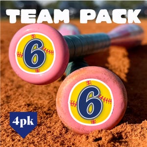 May include: A team pack of pink baseball bats featuring a circular decal on the end cap. The decal displays a yellow softball graphic with red stitching and a large navy blue number 6 in the center. The text TEAM PACK and 4pk are visible.