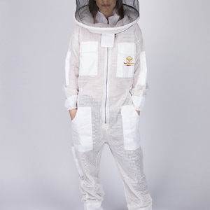 May include: White beekeeping suit with a white mesh veil and hat. The suit has a zipper closure and multiple pockets. The suit has the text "Beekeeping Supplies" embroidered on the chest.