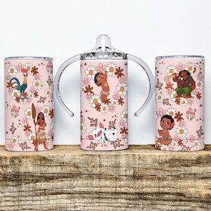 May include: Three pink tumblers with floral designs and cartoon characters. One tumbler has a lid, and the other has handles. The tumblers feature characters from a popular animated movie, surrounded by flowers and leaves.