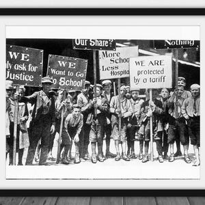 May include: Framed black and white print depicting a protest with signs. The signs read "We ask for Justice" and "We Want to Go to School". The image is a historical photograph of a demonstration.