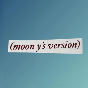 May include: A white paper note with the text "(moon y's version)" written in maroon cursive.
