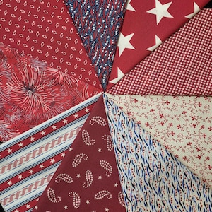 May include: A collection of red, white, and blue fabric swatches arranged in a circular pattern. The fabrics feature various patriotic designs, including stars, stripes, paisley, and floral patterns. The swatches are ideal for quilting or crafting projects.